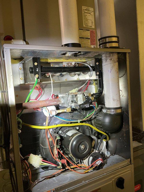 Responded to no-heat call on 2016 furnace installation. Upon arrival, confirmed gas furnace would not initiate heating cycle. Performed diagnostic inspection of unit with access panel removed. Evaluated internal components including blower motor assembly, gas valve, igniter elements, and electrical connections. Checked wiring harnesses and safety controls throughout the system. Assessed overall condition of heating unit and identified cause of failure to start.