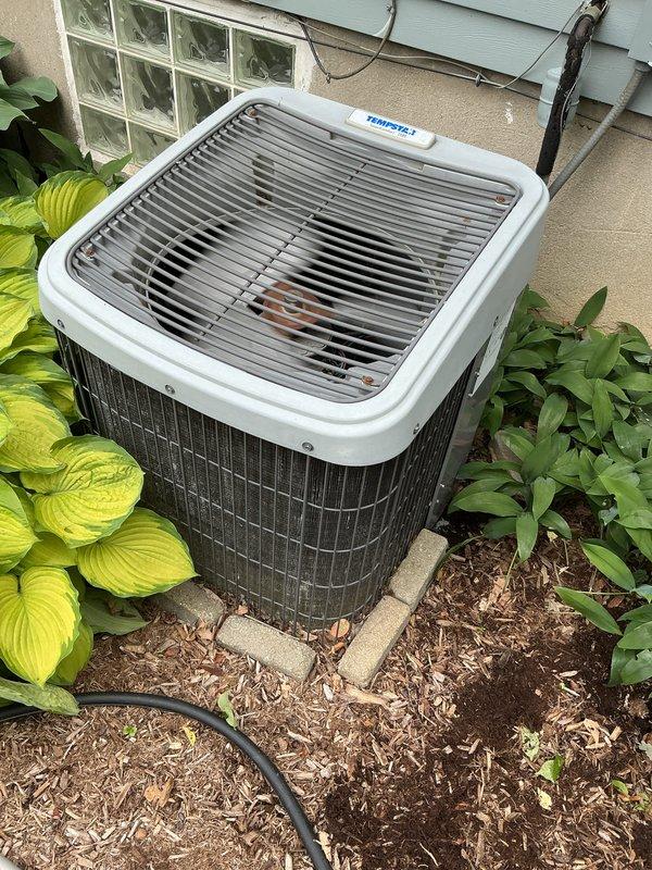 Completed scheduled air conditioning tune-up and preventive maintenance on residential split-system outdoor condenser unit. Performed comprehensive system inspection, verified proper operation of all components, and documented unit condition with photos showing equipment in good working order with adequate clearance from surrounding landscaping.