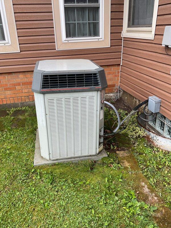 Responded to priority service call for water leaking from HVAC condensate line with unit shut down. Performed comprehensive AC tune-up on residential split system outdoor condenser unit. Inspected refrigerant lines, electrical connections, and condensate drainage system to identify source of reported water leak. Verified proper unit operation, airflow through coils, and secure mounting on concrete pad. System restored to normal cooling operation with leak issue resolved.