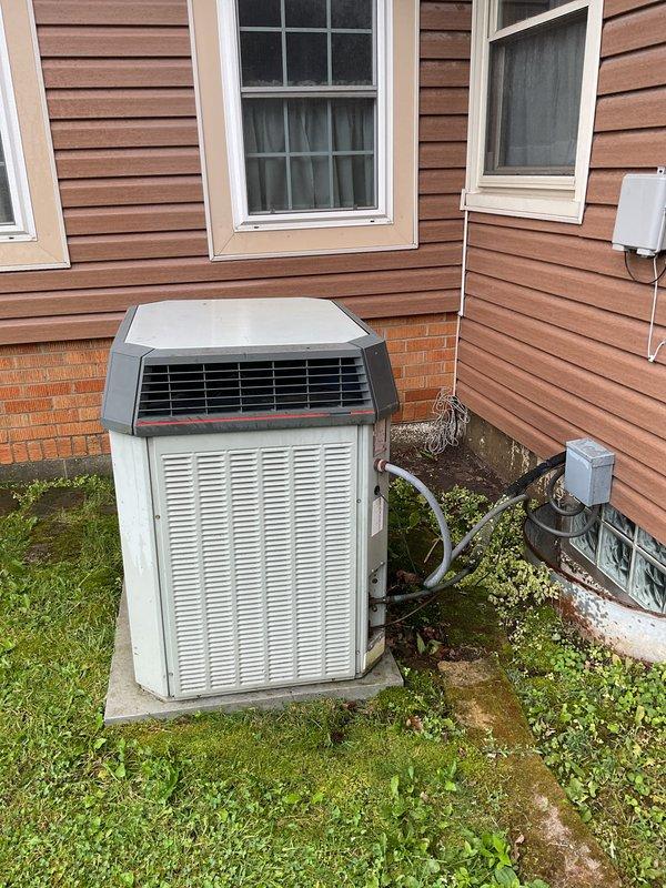 Responded to priority service call for water leaking from HVAC condensate line with unit shut down. Performed comprehensive AC tune-up on residential split system outdoor condenser unit. Inspected refrigerant lines, electrical connections, and condensate drainage system to identify source of reported water leak. Verified proper unit operation, airflow through coils, and secure mounting on concrete pad. System restored to normal cooling operation with leak issue resolved.