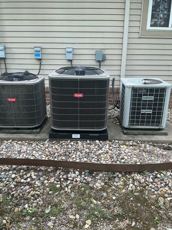 Completed full HVAC system installation including new Bryant furnace and Bryant air conditioning condenser unit. Installed furnace in interior mechanical room with proper ventilation and clearances, connected to existing ductwork system with metal supply and return plenums. Mounted new outdoor condenser unit on composite pad in gravel bed alongside existing equipment against exterior wall with vinyl siding. Ran refrigerant lines between indoor and outdoor units, completed all electrical connections to new service disconnects mounted on exterior wall, and installed condensate drainage system with pump and PVC piping. Tested system operation, verified proper airflow, checked refrigerant charge, and confirmed all safety controls functioning correctly.