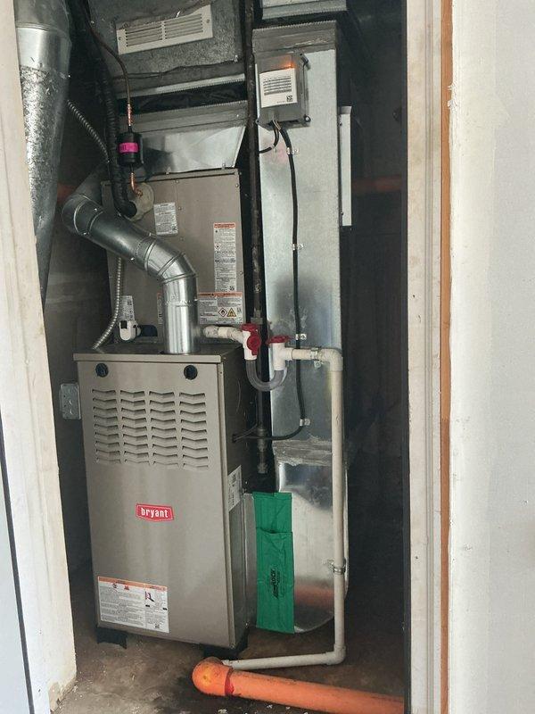 Completed full HVAC system installation including new Bryant furnace and Bryant air conditioning condenser unit. Installed furnace in interior mechanical room with proper ventilation and clearances, connected to existing ductwork system with metal supply and return plenums. Mounted new outdoor condenser unit on composite pad in gravel bed alongside existing equipment against exterior wall with vinyl siding. Ran refrigerant lines between indoor and outdoor units, completed all electrical connections to new service disconnects mounted on exterior wall, and installed condensate drainage system with pump and PVC piping. Tested system operation, verified proper airflow, checked refrigerant charge, and confirmed all safety controls functioning correctly.