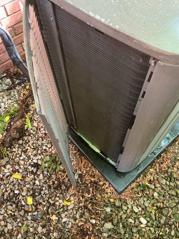 Completed comprehensive AC tune-up on 2023 residential unit as part of prepaid maintenance agreement. System operational with no major issues identified; unit shows normal weathering for outdoor installation with some debris accumulation and surface discoloration present around base and exterior panels.