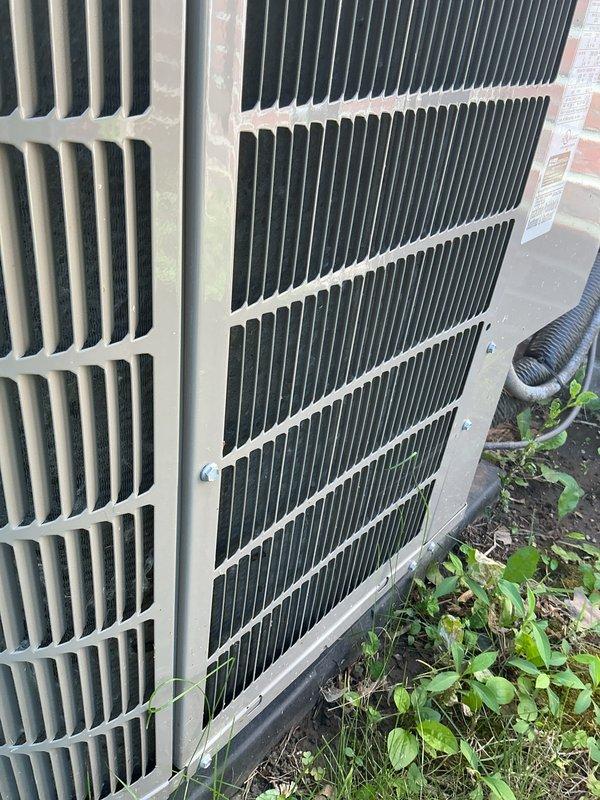 Completed comprehensive preventive maintenance and tune-up service on two outdoor condensing units as part of contract renewal inspection. Both units are newer models in good operational condition, positioned side by side against building exterior. Performed thorough cleaning of condenser coils, removing accumulated dirt, debris, and vegetation growth from unit bases and surrounding areas. Inspected manufacturer labels, electrical connections, and refrigerant lines on both systems. The darker unit showed normal weathering consistent with outdoor exposure, while both units demonstrated proper mounting and drainage configuration. All components tested within normal operating parameters, confirming systems ready for continued reliable service under renewed maintenance agreements.