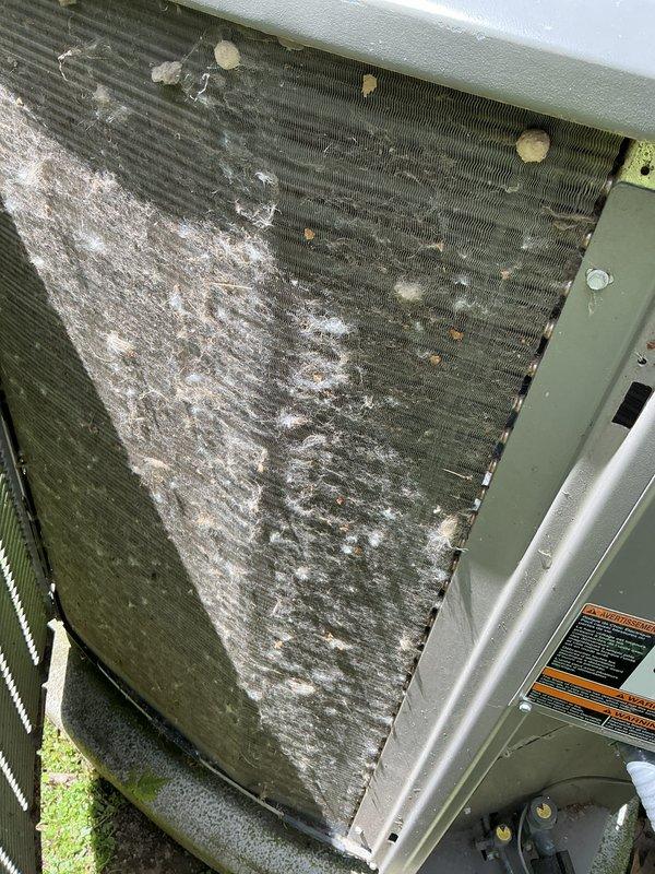 Completed AC maintenance and tune-up on outdoor condensing unit. Upon inspection, found condenser coil heavily caked with dust, debris, and mineral deposits, with significant accumulation obscuring the fins. Exterior cabinet showed extensive dirt streaking and discoloration from environmental exposure. Cleaned condenser coil, removed buildup from fins, and restored proper airflow through the unit to ensure optimal heat transfer and system efficiency.