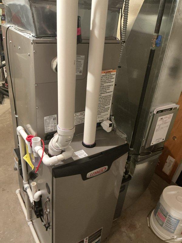 Completed air conditioner installation warranty service addressing a leaking condenser and generator box to disconnect issue. Installed new Lennox HVAC system including furnace unit with proper intake and exhaust venting via dual PVC pipes, integrated air conditioning coil cabinet, metallic ductwork with flexible connections, and associated plumbing drainage system with shutoff valves. Verified all electrical conduit connections, ensured proper equipment mounting and professional pipe routing throughout the installation.