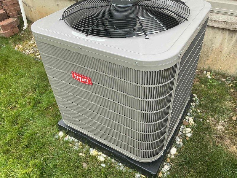 Completed installation of new Bryant outdoor air conditioning condenser unit in residential side yard. Unit was positioned on manufacturer-approved composite pad with gravel base for proper drainage and leveling. Connected refrigerant lines to indoor evaporator coil, performed vacuum and leak test, and charged system to manufacturer specifications. Verified proper electrical connections, tested fan motor operation, and confirmed unit is cycling correctly with appropriate temperature differentials.