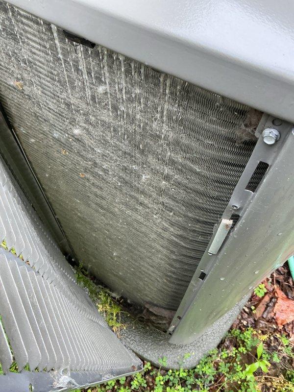 Completed scheduled heat pump tune-up on 2023 residential unit. Performed comprehensive maintenance inspection of outdoor condenser unit, which showed normal wear for age with minor dirt accumulation on exterior housing. Heat exchanger coils exhibited heavy contamination with significant buildup of dirt, dust, and environmental debris restricting airflow through fins. Cleaned condenser coils to restore proper heat transfer efficiency and system performance. Verified refrigerant lines and electrical disconnect box connections were secure. Unit operational and functioning within normal parameters upon completion of maintenance service.