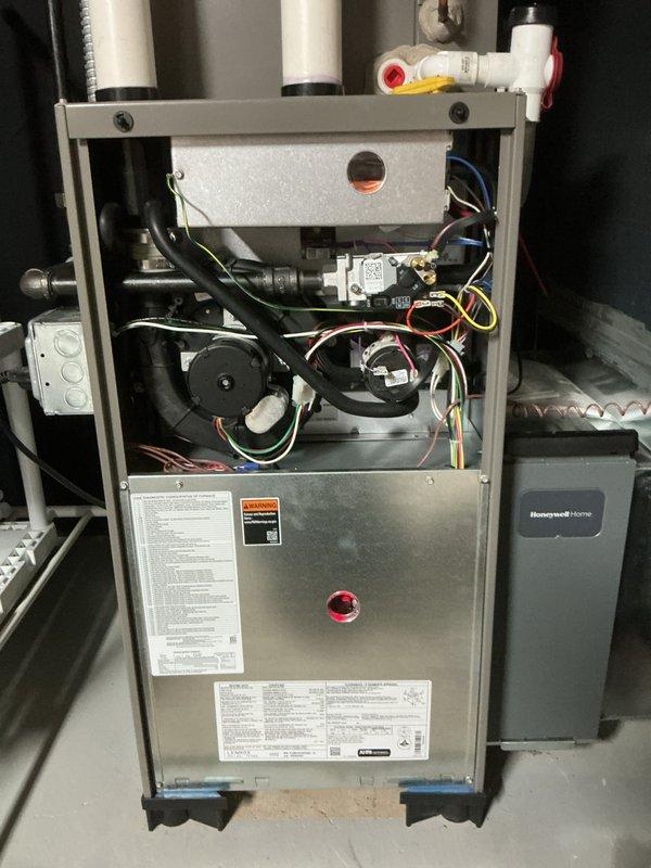 Completed comprehensive tune-up and preventive maintenance on 3-year-old residential heating and cooling system. Performed full inspection of gas furnace internal components including gas valve assembly, blower motor, pressure switches, and dual control boards with all electrical connections verified secure. Inspected heat exchanger, burner assembly, and ignition system with all components operating within manufacturer specifications. Verified proper operation of all safety controls and pressure switches. Checked and confirmed PVC venting system secure with proper drainage. Tested all electrical connections and wire harnesses for integrity. Performed air conditioning system inspection including refrigerant levels, condenser operation, and airflow verification. Changed air filter and cleaned condensate drain system. Cycled both heating and cooling systems through complete operational sequences with all functions performing normally. No deficiencies noted; system operating efficiently an