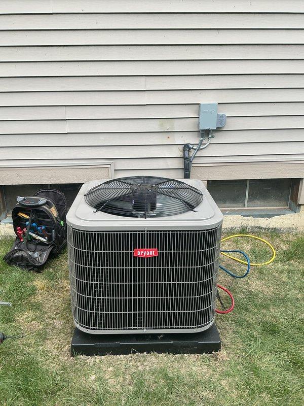 Completed full HVAC system installation including new Bryant air conditioning condenser unit positioned on platform with proper electrical disconnect, new furnace, and humidifier integration. All refrigerant lines connected and charged, system tested and operational, with equipment properly mounted and secured per manufacturer specifications.
