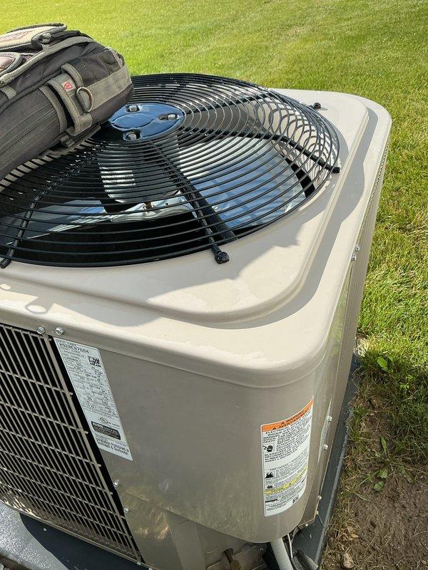 Performed comprehensive air conditioning tune-up on residential outdoor condensing unit. Completed full system inspection, verified proper operation of fan assembly and compressor, checked refrigerant levels, cleaned condenser coils, and confirmed unit specifications against manufacturer requirements. All components found to be operating within normal parameters with no issues identified.