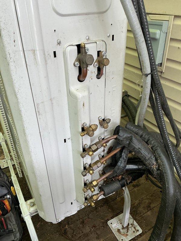 Responded to service call for mini split system with multiple indoor units not cooling properly. Upon inspection, discovered refrigerant lines with damaged insulation and potential leak at outdoor unit connection points. Performed system diagnostics, identified low refrigerant charge, and addressed compromised line connections at exterior service area. Repaired insulation on exposed copper piping and secured all refrigerant line fittings to restore proper system operation.