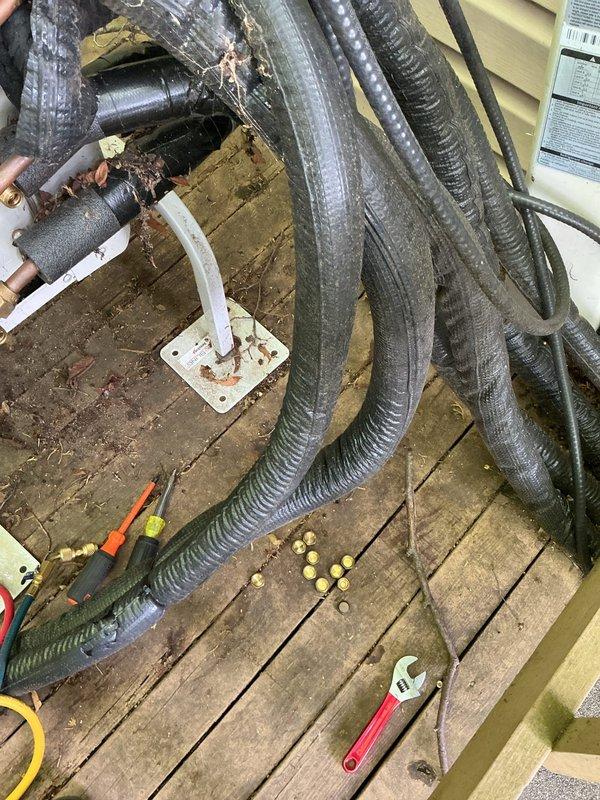 Responded to service call for mini split system with multiple indoor units not cooling properly. Upon inspection, discovered refrigerant lines with damaged insulation and potential leak at outdoor unit connection points. Performed system diagnostics, identified low refrigerant charge, and addressed compromised line connections at exterior service area. Repaired insulation on exposed copper piping and secured all refrigerant line fittings to restore proper system operation.