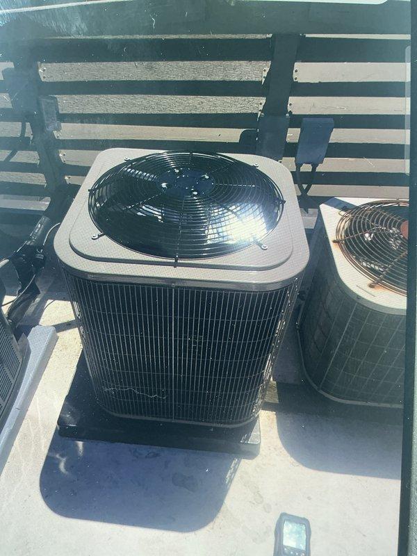 Completed full HVAC system installation including outdoor air conditioning condenser unit and indoor evaporator coil with furnace integration. The outdoor condenser unit was positioned on a rooftop platform with proper clearances and secured to a concrete pad, while the indoor evaporator coil was installed atop the existing furnace in the basement utility area. All refrigerant lines, electrical connections, and ductwork were properly connected and sealed to ensure optimal system performance and efficiency.