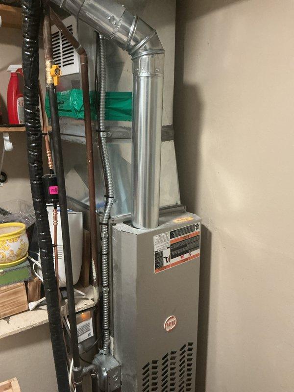 Completed full HVAC system installation including outdoor air conditioning condenser unit and indoor evaporator coil with furnace integration. The outdoor condenser unit was positioned on a rooftop platform with proper clearances and secured to a concrete pad, while the indoor evaporator coil was installed atop the existing furnace in the basement utility area. All refrigerant lines, electrical connections, and ductwork were properly connected and sealed to ensure optimal system performance and efficiency.