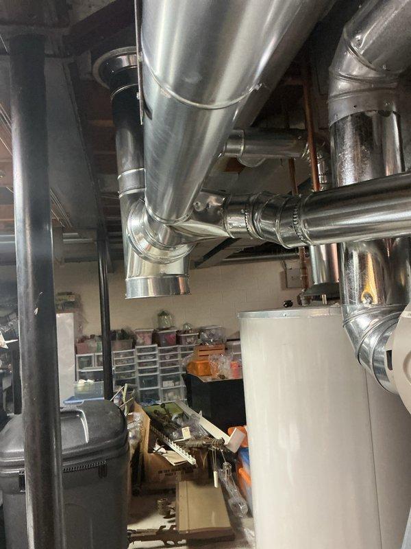 Returned to property to complete venting modifications on previously installed HVAC system. Corrected ductwork configuration in mechanical room, ensuring proper ventilation routing and secure connections throughout the system. Documented completed repairs with photographs showing modified ductwork assembly and mechanical room conditions upon completion of callback service.