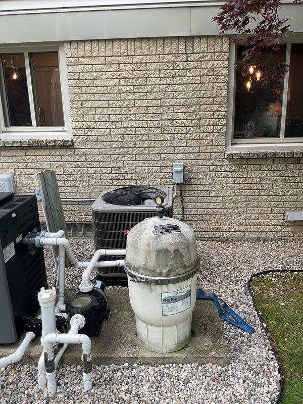 Completed full HVAC system installation including new furnace, air conditioner, humidifier, and chimney liner. Bryant outdoor condensing unit installed on gravel pad with proper electrical disconnect and refrigerant line protection. All equipment positioned per code requirements with appropriate clearances, electrical connections verified, and system tested for proper operation.
