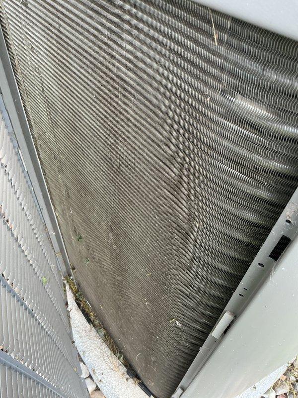 Completed preventative maintenance tune-up on two air conditioning systems. Inspected heat exchanger coils and condenser assemblies, noting moderate accumulation of dirt, debris, and dust on both units' aluminum fins with heavier buildup concentrated at base sections. Performed standard seasonal maintenance procedures including system performance verification and operational testing to ensure proper cooling functionality.