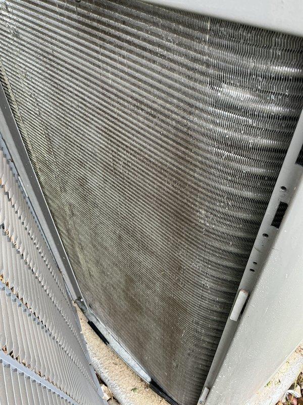 Completed preventative maintenance tune-up on two air conditioning systems. Inspected heat exchanger coils and condenser assemblies, noting moderate accumulation of dirt, debris, and dust on both units' aluminum fins with heavier buildup concentrated at base sections. Performed standard seasonal maintenance procedures including system performance verification and operational testing to ensure proper cooling functionality.