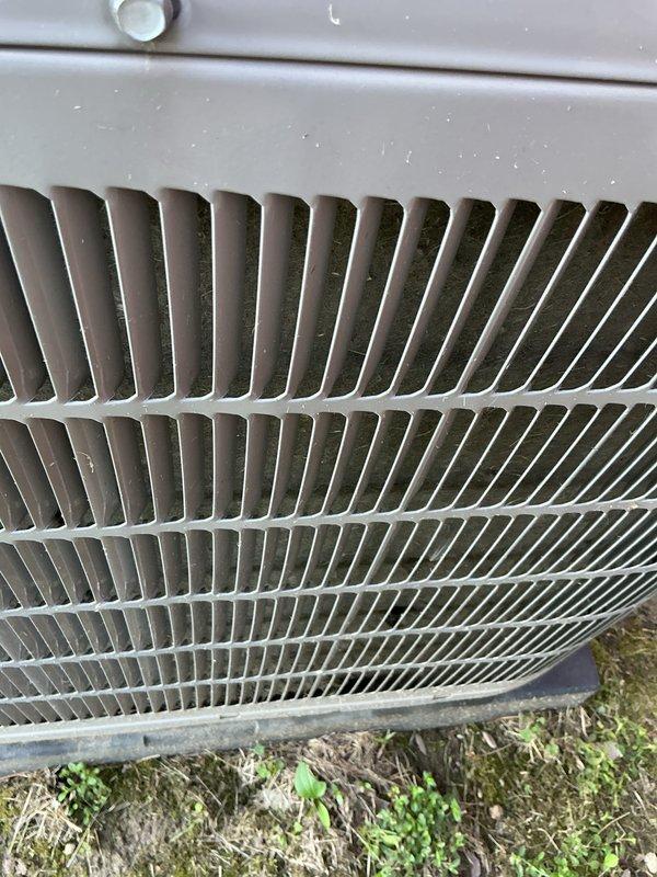 Completed preventive maintenance tune-up on 2022 residential outdoor condensing unit. Performed comprehensive inspection of condenser coil fins, protective grille assembly, and exterior casing, confirming all components in good operational condition with normal weathering consistent with outdoor exposure. Unit tested and operating within manufacturer specifications.
