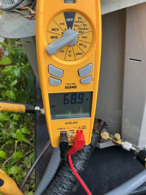 Completed annual AC maintenance on a four-year-old residential cooling system with no reported issues or symptoms. Performed comprehensive tune-up procedures on the outdoor condensing unit, including electrical performance testing with amperage readings confirming proper compressor operation at 68.9 amps. System found operating within normal parameters with all components functioning correctly.