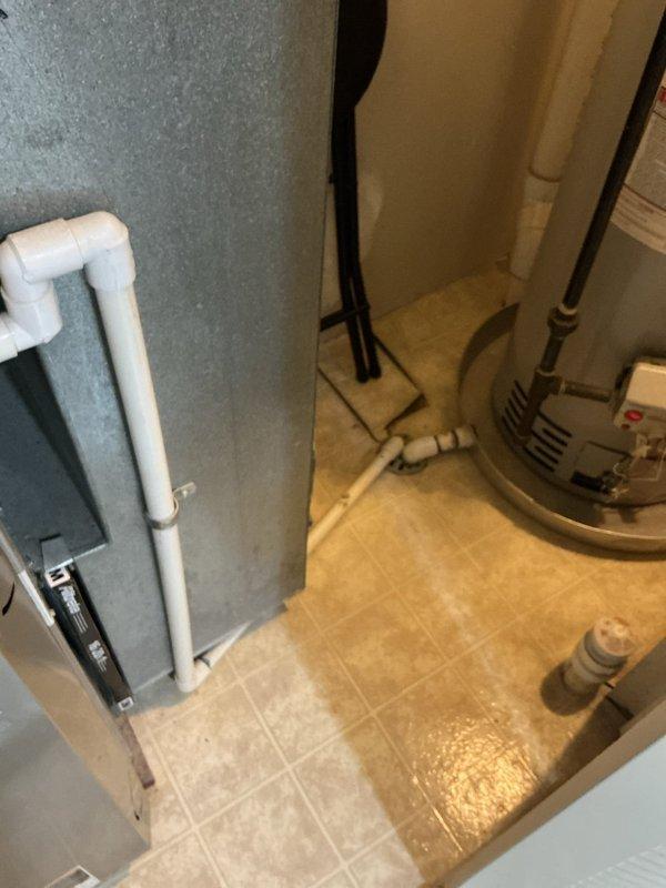 Responded to service call for AC unit freezing and inadequate cooling. Upon arrival, found evidence of excessive condensation in mechanical closet with visible moisture on floor around air handler and furnace area. Inspected Bryant furnace system and associated ductwork, noting rust streaking on galvanized ductwork indicating prolonged moisture exposure. Evaluated evaporator coil freezing condition and identified restricted airflow as primary cause. Checked refrigerant levels, airflow patterns, and drainage system. Cleared condensate drain line blockage causing water backup. System returned to normal operation with proper cooling restored.