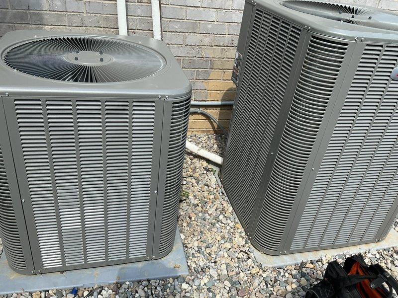 Completed preventive maintenance tune-ups on two residential air conditioning systems located side by side on exterior gravel pad. Both condenser units were inspected, tested, and serviced according to standard maintenance protocols, with membership enrollment processed at time of service.