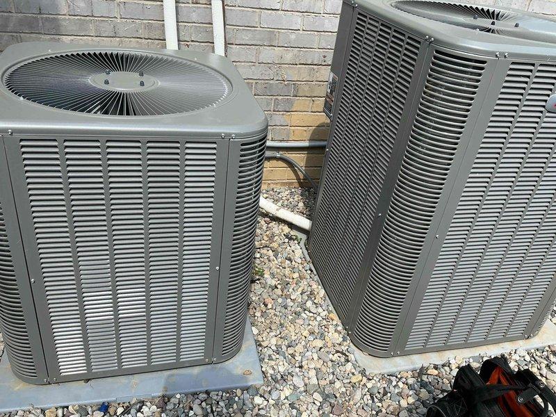 Completed preventive maintenance tune-ups on two residential air conditioning systems located side by side on exterior gravel pad. Both condenser units were inspected, tested, and serviced according to standard maintenance protocols, with membership enrollment processed at time of service.