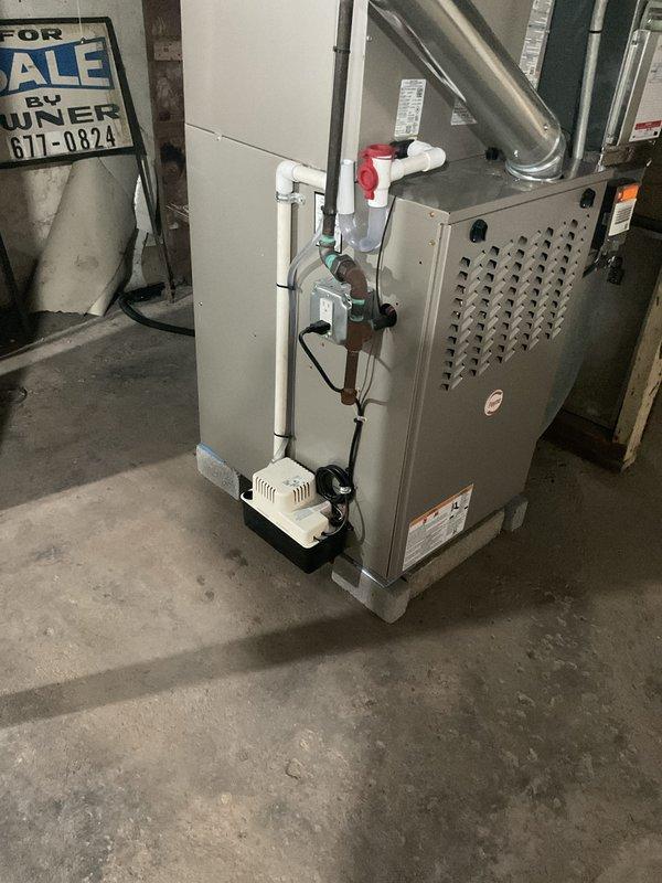 Completed installation of new air conditioning system and evaporator coil in residential basement mechanical room. System was properly mounted, connected to existing ductwork, and integrated with condensate drainage system including pump and emergency overflow protection. All electrical connections, refrigerant lines, and PVC drainage piping were installed per manufacturer specifications and local code requirements, with system tested and confirmed operational upon completion.
