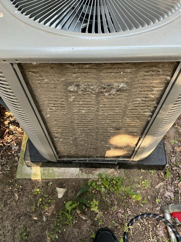 Completed annual air conditioning tune-up on outdoor condensing unit. Inspected condenser coils, which showed moderate dirt accumulation and discoloration, and cleaned exterior surfaces. Unit is approximately two years old and operating within normal parameters.