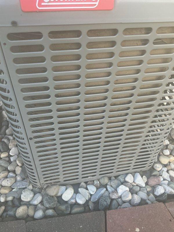 Completed comprehensive air conditioning tune-up on Coleman outdoor unit. Performed standard maintenance procedures including inspection of condenser coil through exterior grille, verified proper airflow through ventilation slots, and assessed overall unit condition. Equipment found to be operating within normal parameters with grille and internal components showing acceptable wear for outdoor installation.