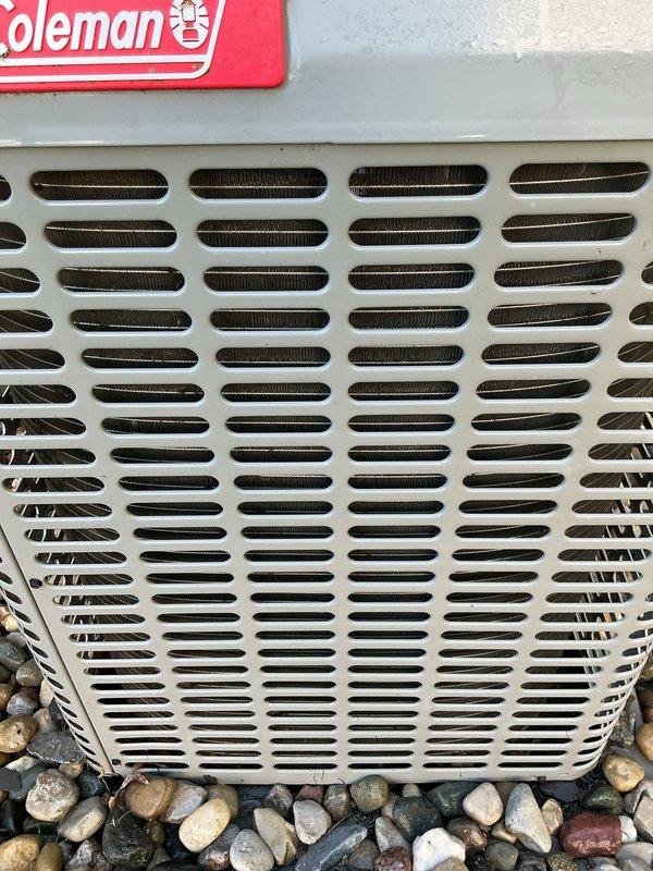 Completed comprehensive air conditioning tune-up on Coleman outdoor unit. Performed standard maintenance procedures including inspection of condenser coil through exterior grille, verified proper airflow through ventilation slots, and assessed overall unit condition. Equipment found to be operating within normal parameters with grille and internal components showing acceptable wear for outdoor installation.