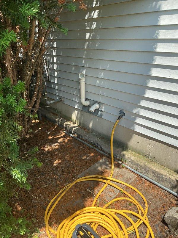 Completed installation of new Bryant HVAC system including air conditioning unit and evaporator coil. Installed furnace unit in basement utility area with proper venting system using white PVC piping for condensate drainage and exhaust. Mounted and connected outdoor condensing unit on exterior of building with appropriate refrigerant line set and electrical connections. Configured electrical service with junction box and conduit runs to support new equipment. Installed humidifier component integrated with furnace system. Routed all drainage lines to exterior discharge point with proper pitch and support. Verified all refrigerant connections are sealed and leak-free, system charged to manufacturer specifications. Tested full system operation including heating, cooling, and humidity control functions. All components operating within normal parameters and installation meets code requirements.