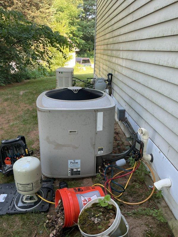 Performed warranty service on 2018 residential air conditioning system. Connected manifold gauges to service ports and diagnosed refrigerant system performance on outdoor condensing unit. Unit operational at time of inspection with condenser coils and fan assembly functioning properly.