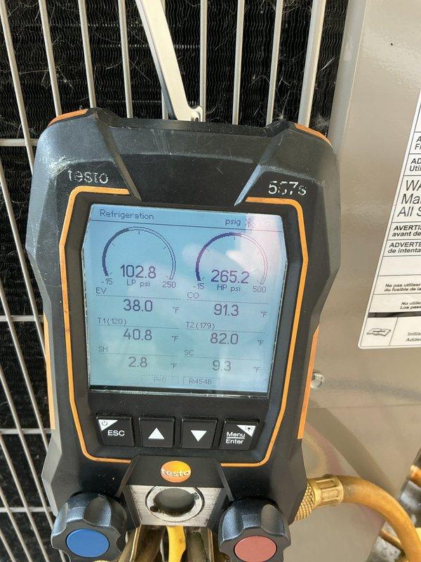 Responded to no cooling complaint on recently installed system under full warranty. Upon arrival, performed complete system diagnostics using refrigerant gauges to verify operating pressures and temperatures. Measured suction pressure at 102-107 psi and discharge pressure at 265-277 psi, with corresponding temperature readings indicating system was cycling properly and operating within manufacturer specifications. Verified all components functioning correctly with no defects found.