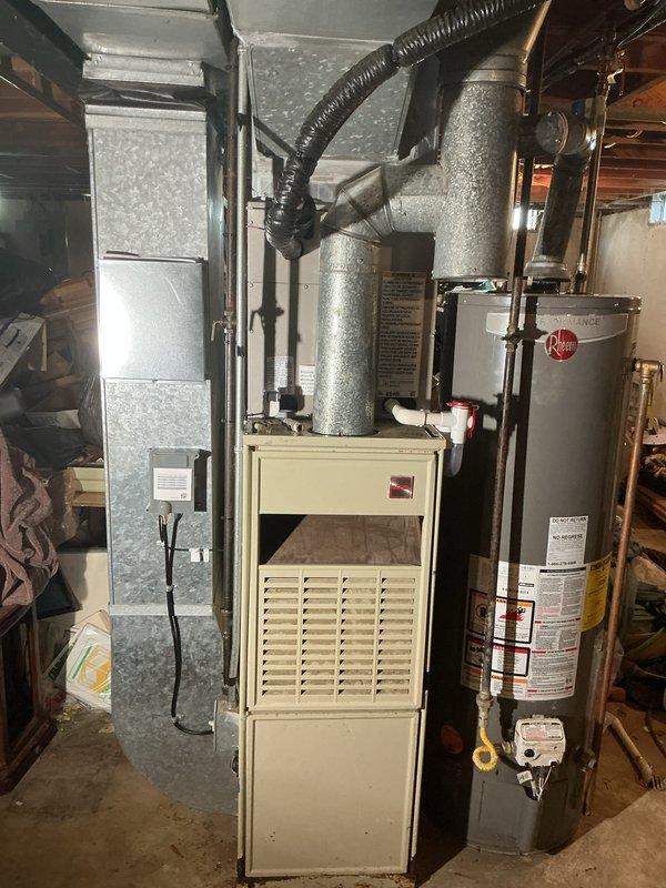 Completed installation of new air conditioning system with evaporator coil in residential basement mechanical room. New A-frame evaporator coil was mounted above existing furnace unit and integrated with galvanized supply plenum and distribution ductwork. Connected refrigerant lines to outdoor condensing unit, pressure tested system, evacuated to proper vacuum levels, and charged with manufacturer-specified refrigerant. Verified proper airflow across coil, confirmed adequate condensate drainage, and tested system operation through complete cooling cycle. All connections sealed and insulated per code requirements, with system achieving target temperature differential and operating within normal parameters.