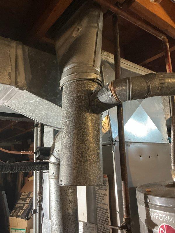 Completed installation of new air conditioning system with evaporator coil in residential basement mechanical room. New A-frame evaporator coil was mounted above existing furnace unit and integrated with galvanized supply plenum and distribution ductwork. Connected refrigerant lines to outdoor condensing unit, pressure tested system, evacuated to proper vacuum levels, and charged with manufacturer-specified refrigerant. Verified proper airflow across coil, confirmed adequate condensate drainage, and tested system operation through complete cooling cycle. All connections sealed and insulated per code requirements, with system achieving target temperature differential and operating within normal parameters.