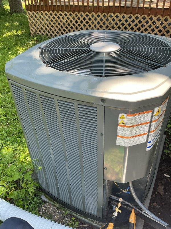 Completed comprehensive AC tune-up on outdoor condensing unit. Performed full system inspection with access panel removal to examine internal components including capacitor, refrigerant lines, and electrical connections. Cleaned accumulated dirt and debris from internal compartment, verified proper operation of condenser fan, and ensured all connections were secure and functioning within manufacturer specifications.