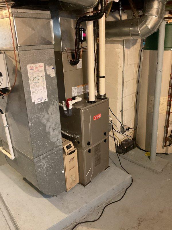 Completed installation of new Bryant heat pump system including outdoor condenser unit and indoor air handler. Outdoor unit was mounted on concrete pad with proper electrical disconnect and line set installation, while indoor air handler was installed in basement mechanical room with appropriate condensate drainage and ductwork connections. All components were properly wired, refrigerant lines were connected and tested, and system was commissioned to ensure optimal heating and cooling performance.