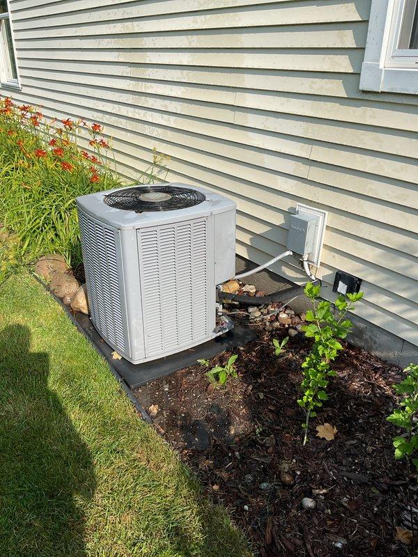 Completed scheduled air conditioning tune-up on residential outdoor condensing unit. Performed comprehensive maintenance inspection including checking refrigerant levels, cleaning condenser coils, testing electrical connections at disconnect box, verifying proper airflow through fan grille, and inspecting line sets entering the structure. Unit operating within normal parameters with no issues identified.
