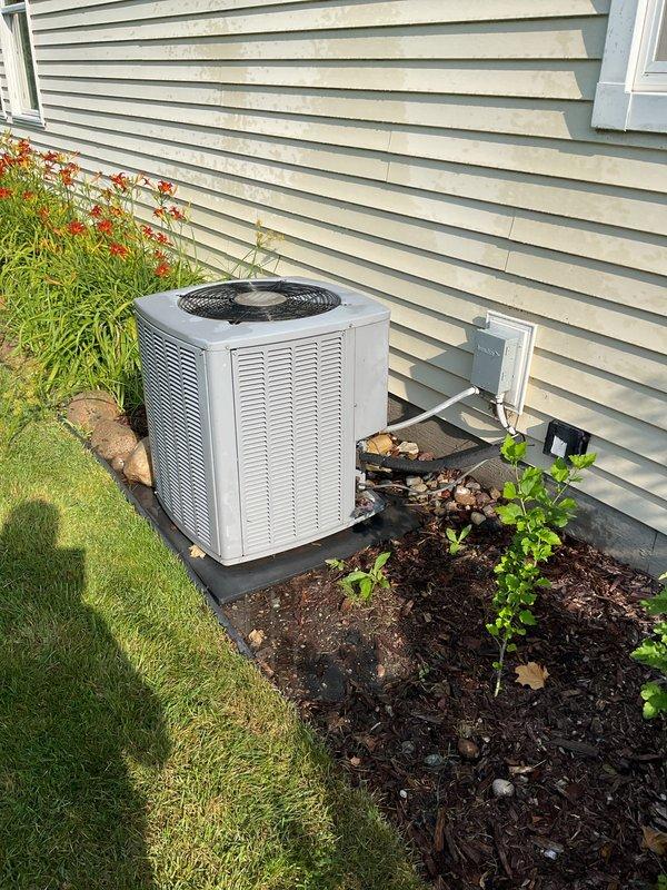 Completed scheduled air conditioning tune-up on residential outdoor condensing unit. Performed comprehensive maintenance inspection including checking refrigerant levels, cleaning condenser coils, testing electrical connections at disconnect box, verifying proper airflow through fan grille, and inspecting line sets entering the structure. Unit operating within normal parameters with no issues identified.