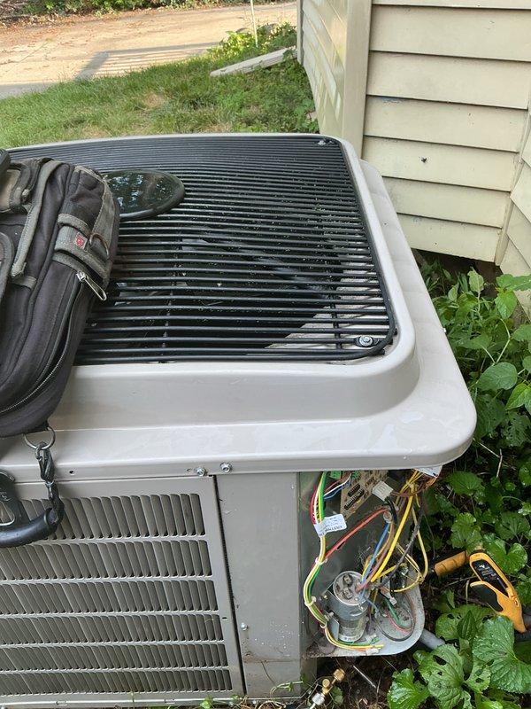 Responded to cooling system service call and performed diagnostic testing on outdoor condensing unit. Accessed internal electrical components, utilized digital multimeter to measure voltage and verify proper electrical operation, confirmed system readings within normal parameters at 898 reading during testing. Completed electrical diagnostics, reassembled unit, and restored system to normal cooling operation.