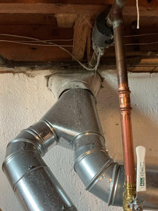 Completed installation of new air conditioning system with evaporator coil in residential basement. Connected ductwork to existing HVAC infrastructure, installed condensate pump and drain system, and verified all electrical connections and refrigerant lines are properly secured and operational.