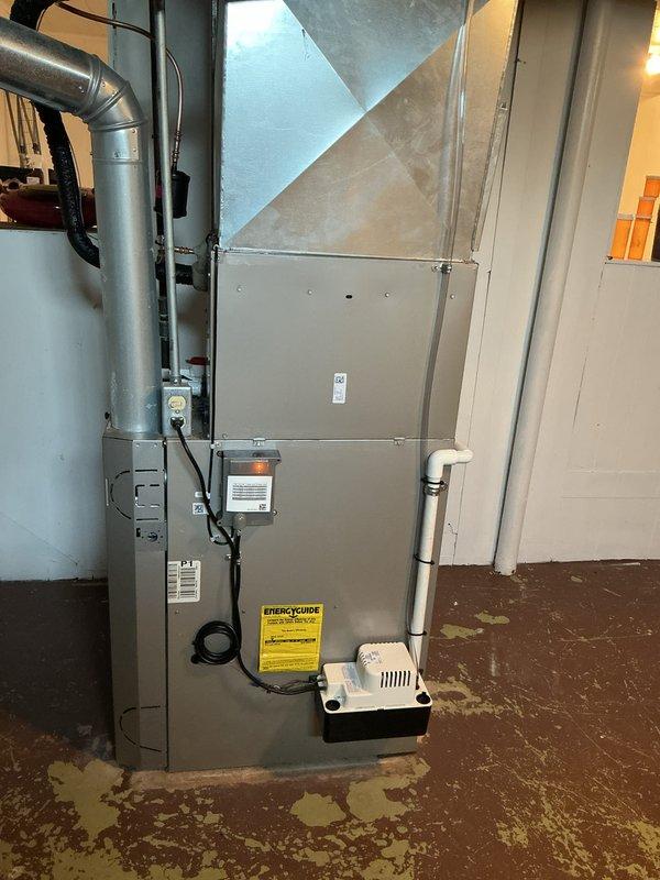 Completed installation of new air conditioning system with evaporator coil in residential basement. Connected ductwork to existing HVAC infrastructure, installed condensate pump and drain system, and verified all electrical connections and refrigerant lines are properly secured and operational.