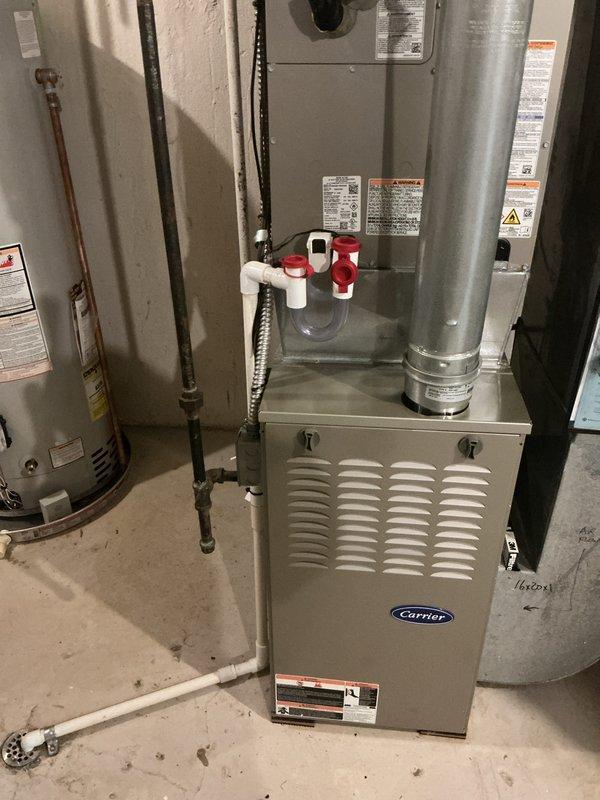 Completed installation of new Bryant outdoor condensing unit and matching evaporator coil to work in conjunction with existing Carrier furnace system. Outdoor unit was positioned on composite pad with stone base and proper clearances from structure, with refrigerant lines and electrical connections routed through exterior wall. System was pressure tested, evacuated, charged to manufacturer specifications, and verified for proper operation with airflow and temperature differential measurements within acceptable range.