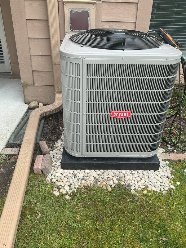 Completed installation of new Bryant outdoor condensing unit and matching evaporator coil to work in conjunction with existing Carrier furnace system. Outdoor unit was positioned on composite pad with stone base and proper clearances from structure, with refrigerant lines and electrical connections routed through exterior wall. System was pressure tested, evacuated, charged to manufacturer specifications, and verified for proper operation with airflow and temperature differential measurements within acceptable range.
