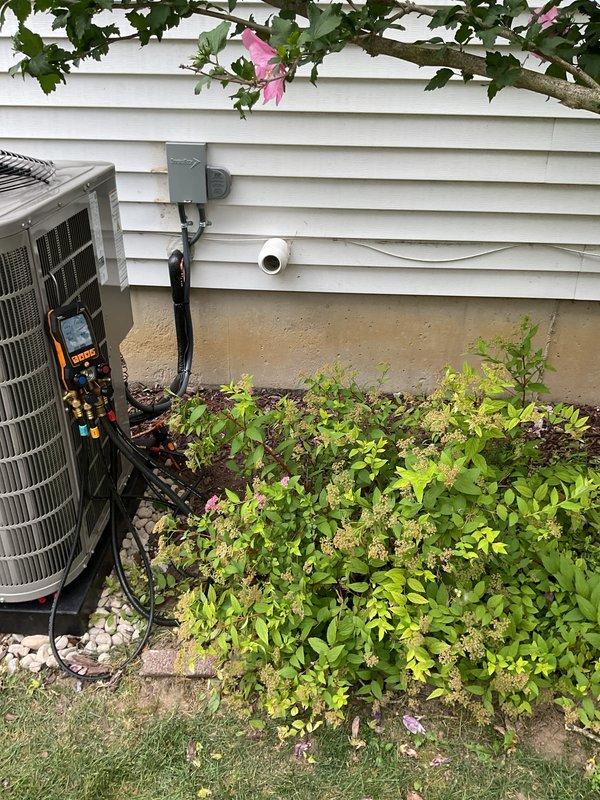 Completed installation of new air conditioning system including outdoor condensing unit and indoor evaporator coil. Installed outdoor unit on exterior wall with proper refrigerant line set, electrical disconnect, and condensate drainage. Connected indoor evaporator coil to existing air handler in basement utility area with new PVC condensate drain line routed to floor drain. System tested and verified operational with proper refrigerant charge and airflow.