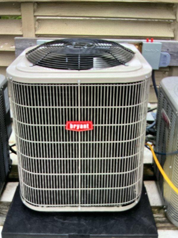 Completed installation of new Bryant air conditioning system including outdoor condensing unit and indoor evaporator coil. Outdoor unit was positioned on platform with proper electrical disconnect and conduit installation per code requirements. Indoor evaporator coil was installed atop existing furnace in utility space with refrigerant lines and flexible ductwork properly connected. System was fully charged, tested for proper operation, and all components verified functional with no leaks detected.