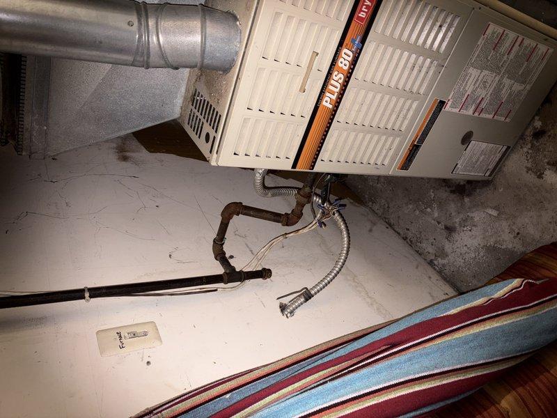 Responded to customer complaint of rattling noise from AC unit. Upon inspection, identified loose ductwork connection at the furnace plenum and degraded flexible condensate drain line. Secured and adjusted metallic ductwork at elbow joint to eliminate vibration and rattling. Inspected PLUS 90i furnace unit and associated HVAC components for proper operation. Tightened all accessible duct connections and verified system stability. Condensate drain line showing wear but functioning adequately at time of service.