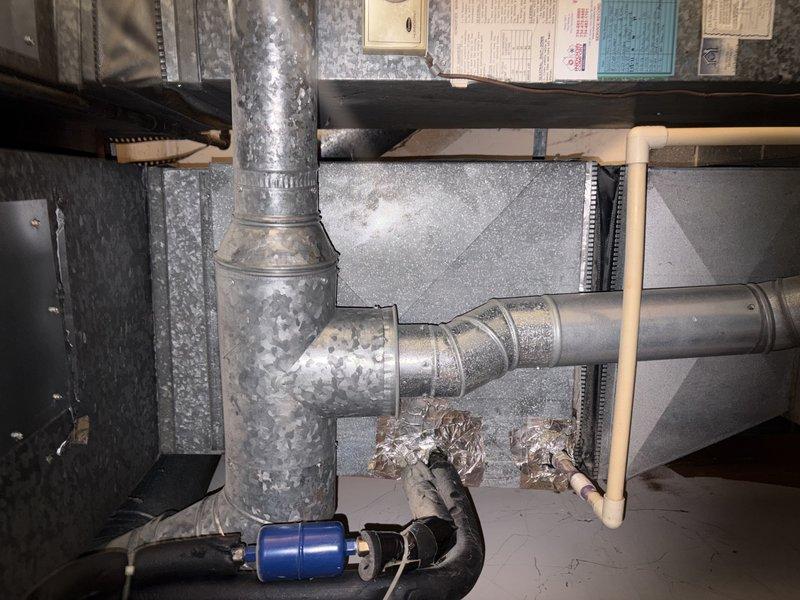 Responded to customer complaint of rattling noise from AC unit. Upon inspection, identified loose ductwork connection at the furnace plenum and degraded flexible condensate drain line. Secured and adjusted metallic ductwork at elbow joint to eliminate vibration and rattling. Inspected PLUS 90i furnace unit and associated HVAC components for proper operation. Tightened all accessible duct connections and verified system stability. Condensate drain line showing wear but functioning adequately at time of service.